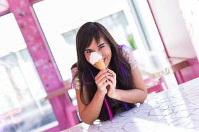 Portrait of young woman eating food