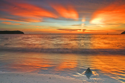 Scenic view of sea against orange sky