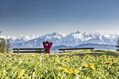 Rear view of woman looking at snowcapped mountains