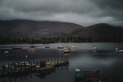 Boats on a very still lake derwent water in the lake district on an overcast day