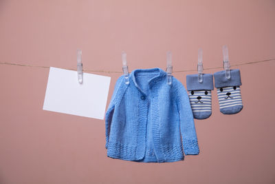 Close-up of clothes drying against blue wall