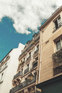 Low angle view of building against cloudy sky