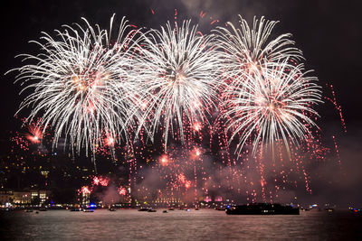 Low angle view of firework display at night