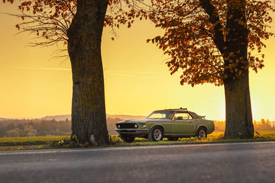 Car on road against sky during sunset