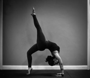 Woman performing cartwheel at gymnasium