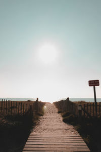 View of boardwalk against clear sky