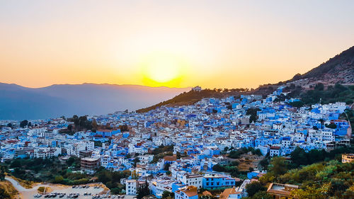 High angle shot of townscape against sky during sunset