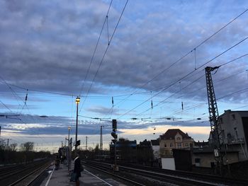 Cars on bridge over city against sky