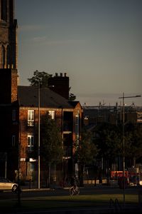 Street by buildings in city against sky