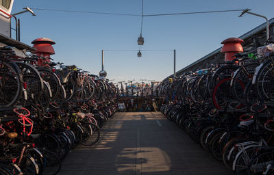 Bicycles parked at station against clear sky