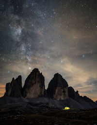 Scenic view of rock formations against sky at night