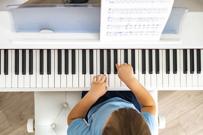 Low section of girl playing on bed