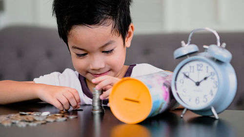 Portrait of boy on table at home