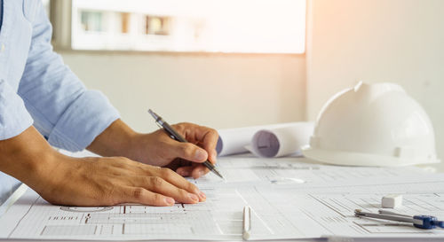 Midsection of man working on table