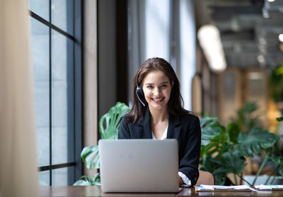 Portrait of woman working on table