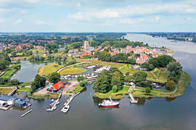 Aerial from the city woudrichem at the river merwede in the netherlands in a flooded landscape