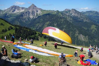 People on mountain road against mountains