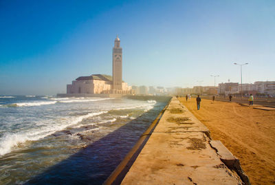 Panoramic view of sea and city against clear sky