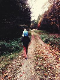 Rear view of woman walking on landscape