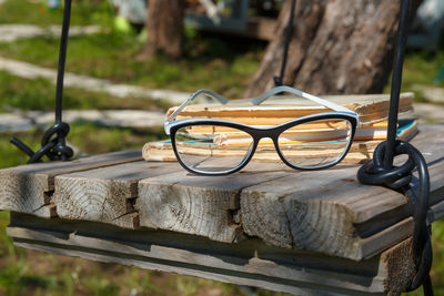 Old books and glasses on a homemade retro swing