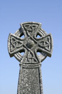 Low angle view of cross against clear blue sky