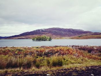 Scenic view of lake and mountains against sky