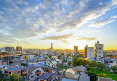 High angle view of buildings against cloudy sky