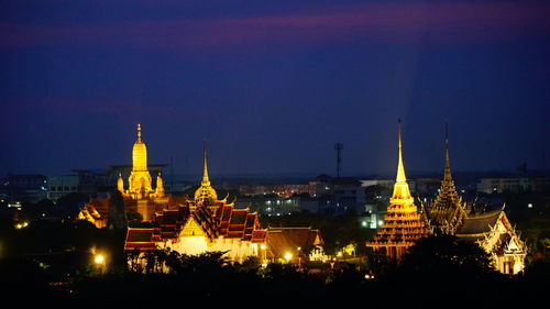 Illuminated buildings in city at night