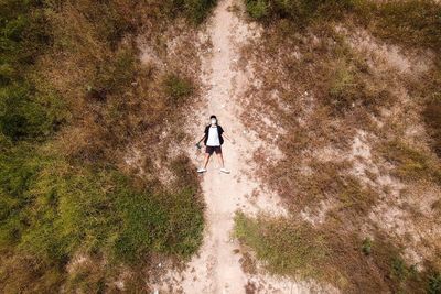 High angle view of man lying on landscape