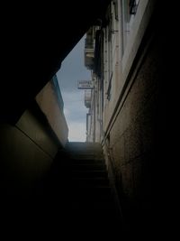 Low angle view of steps amidst buildings