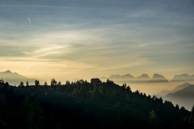 Scenic view of silhouette mountains against sky at sunset