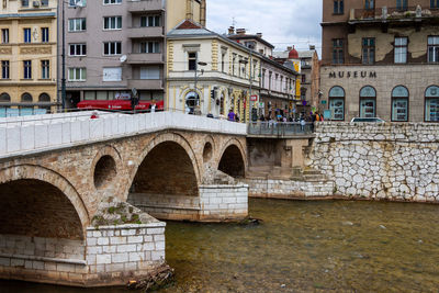 Arch bridge over river in city