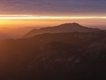 Scenic view of silhouette mountains against sky during sunset