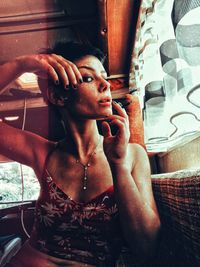 Portrait of woman with reflection on window