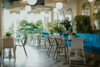 Empty chairs and tables in restaurant