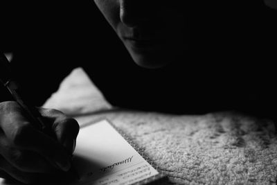 Close-up of hand holding book