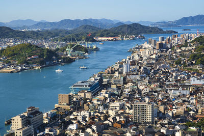 High angle view of onomichi city by sea against sky