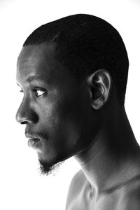 Close-up portrait of young man against white background