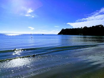 Scenic view of beach against blue sky