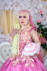 Portrait of woman with pink flowers