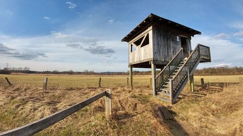Traditional windmill on field against sky