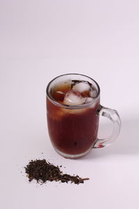 Close-up of coffee on table against white background