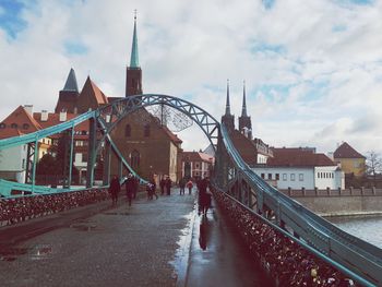 View of buildings in town against cloudy sky