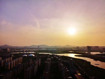 High angle view of buildings against sky during sunset