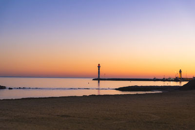 Scenic view of sea against clear sky during sunset