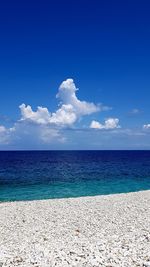 Scenic view of sea against blue sky