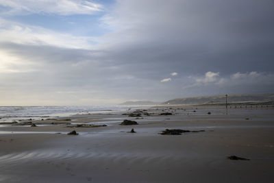 Scenic view of beach against sky during sunset