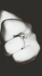 Close-up of woman hand over black background