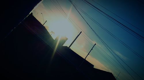 Low angle view of power lines against sky