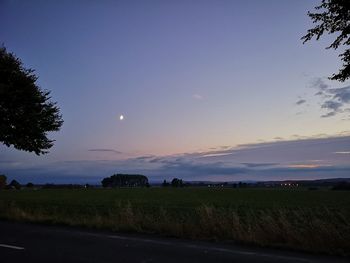 Scenic view of field against sky during sunset